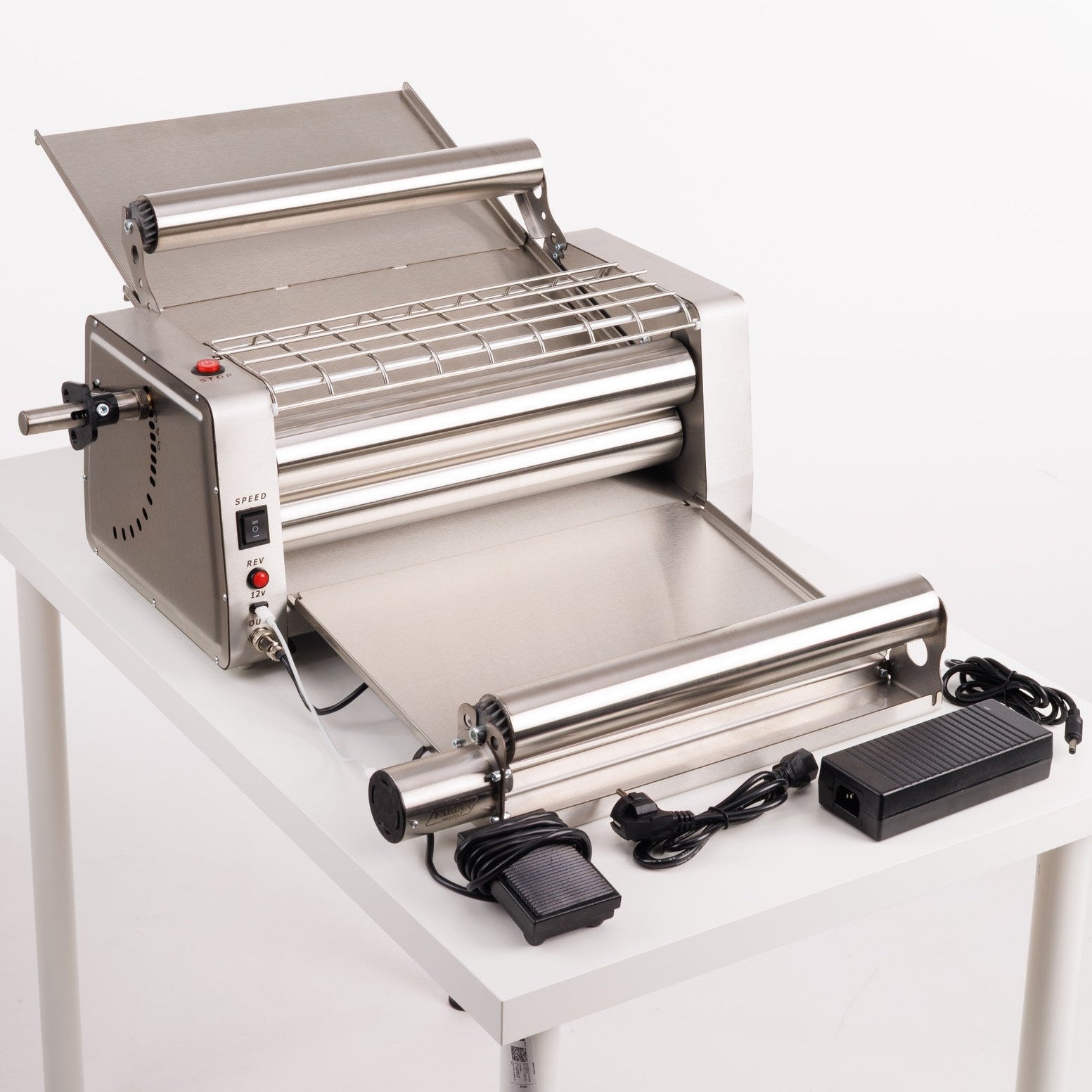 Stainless steel pasta machine on a white background