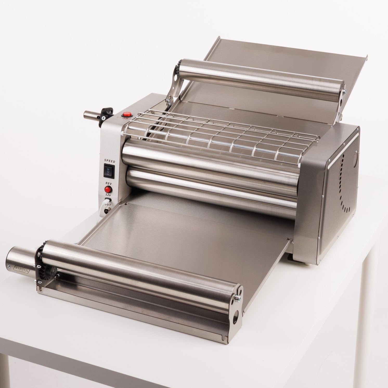 Stainless steel dough sheeter on a white background