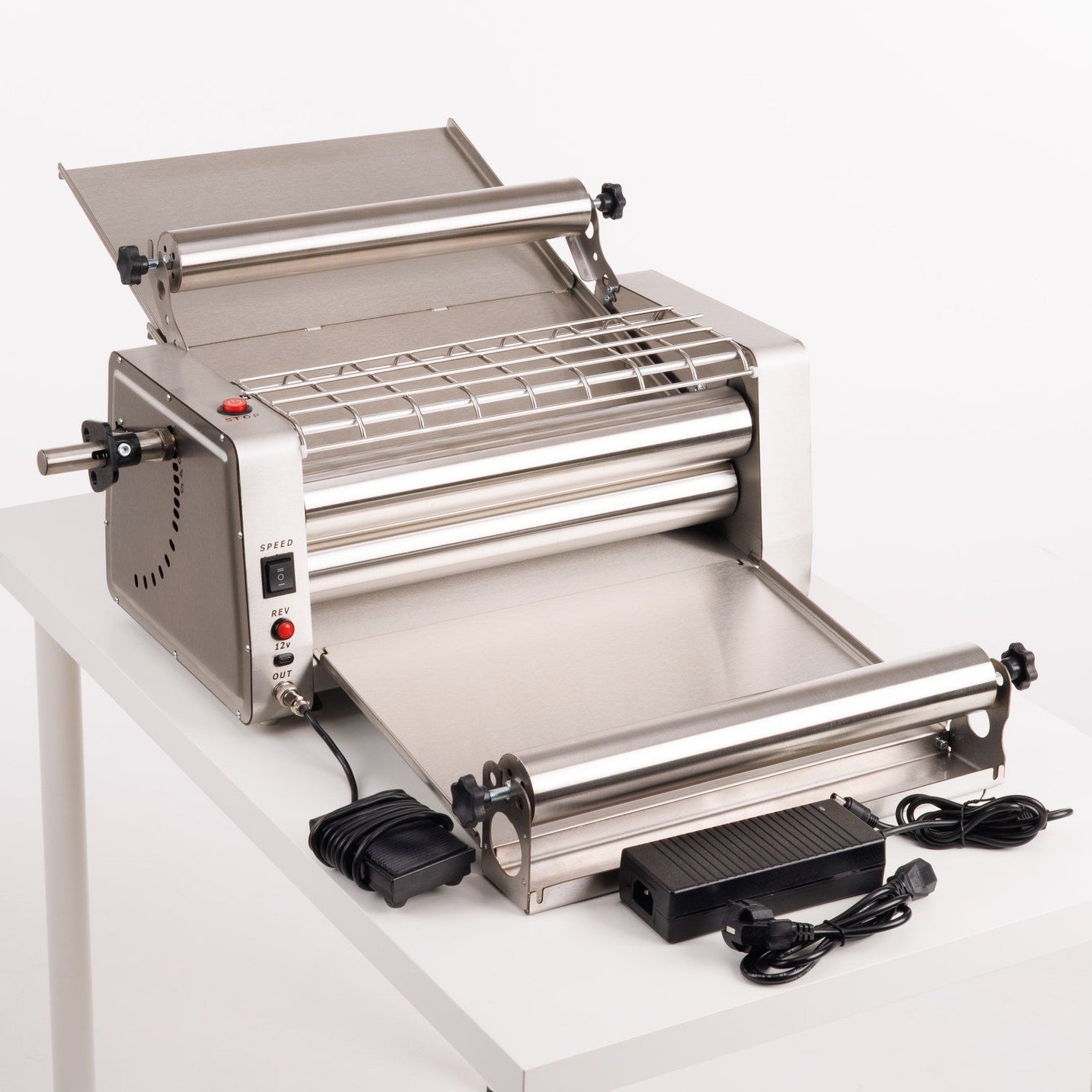 Roller machine on a white table with a white background